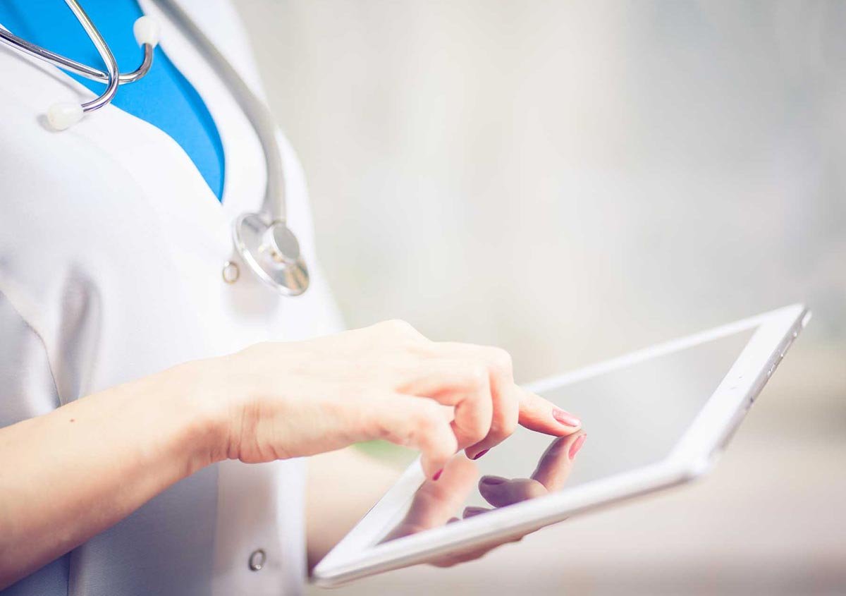 A doctor working on a tab