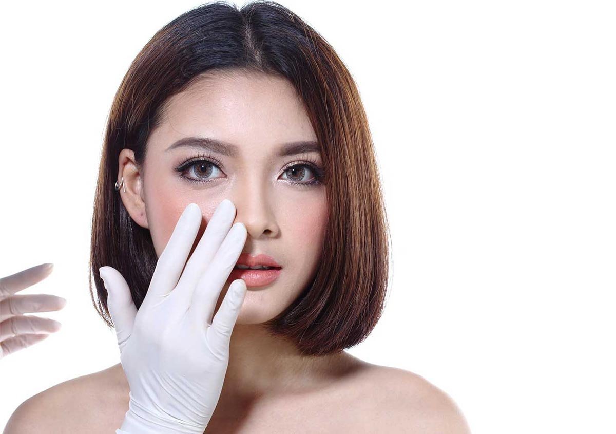 A woman getting her face examined
