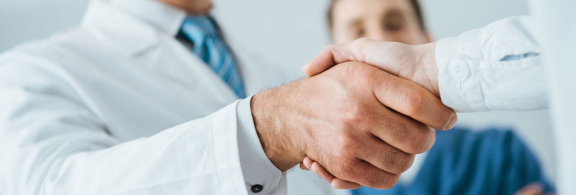 A doctor shaking hands with a patient