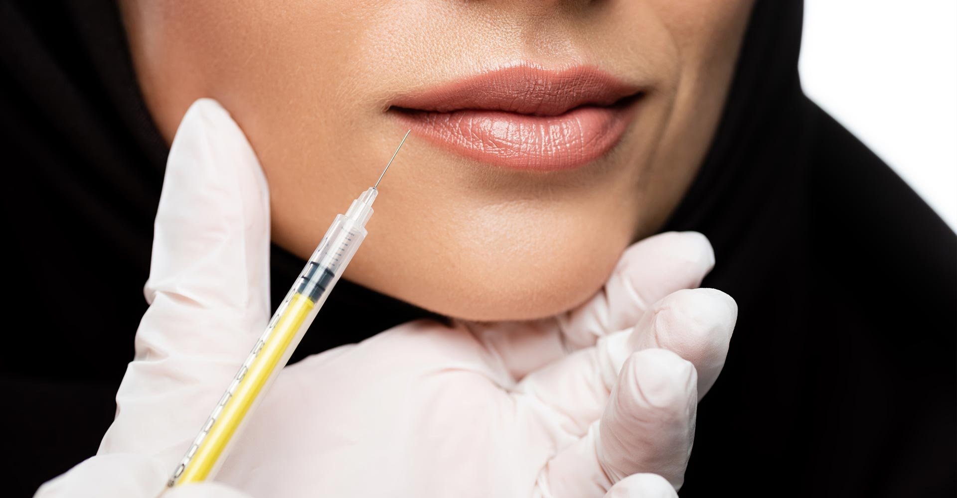 Cropped view of young Muslim woman in hijab having beauty injection