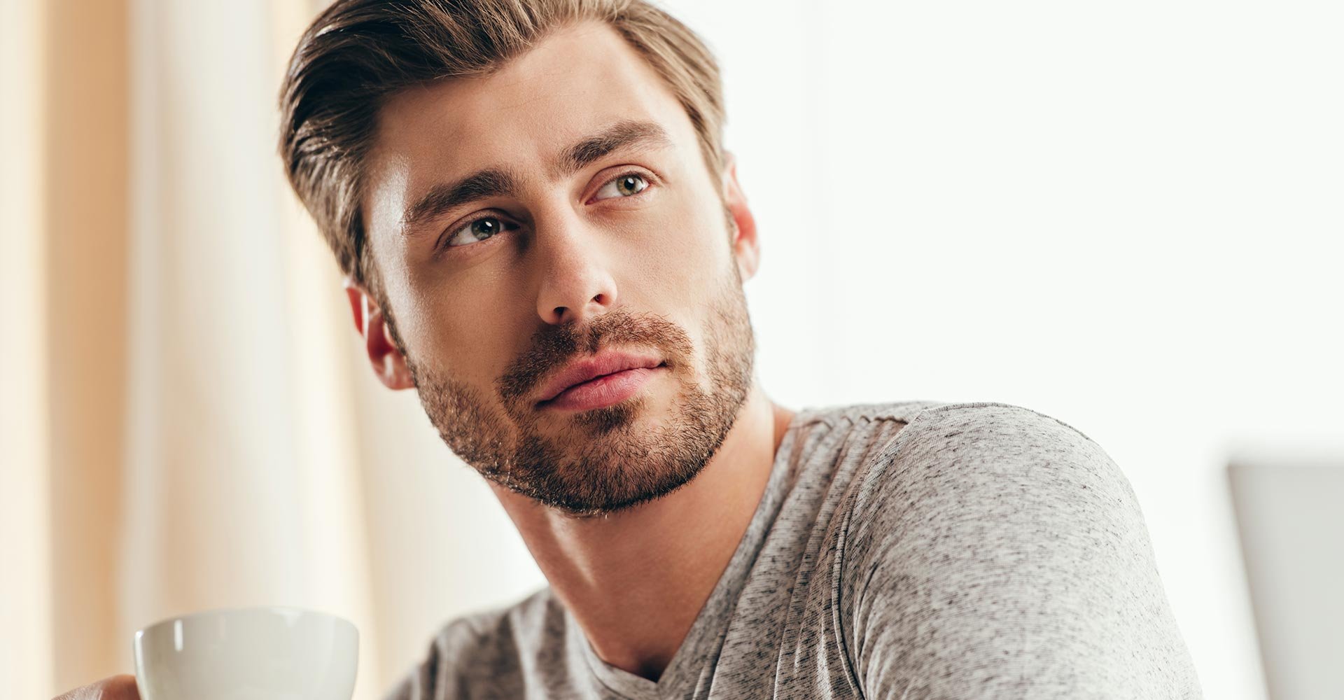 Handsome man drinking coffee at home
