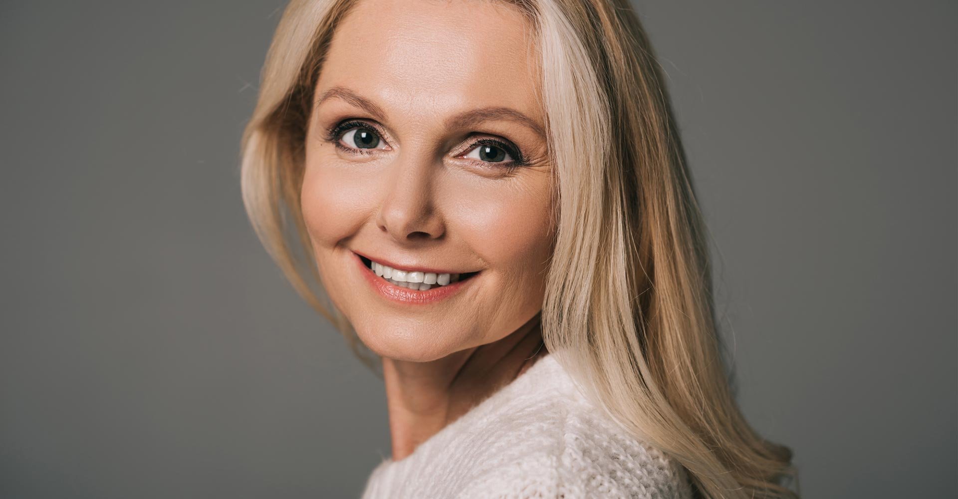 Mature woman in white sweater