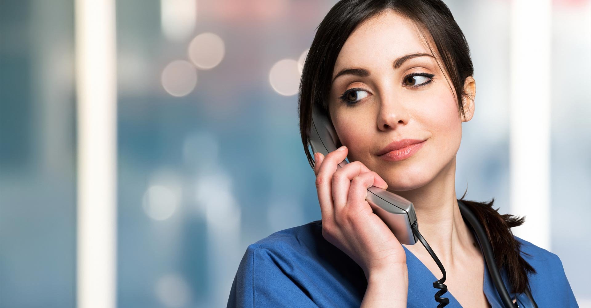 Smiling nurse talking on phone