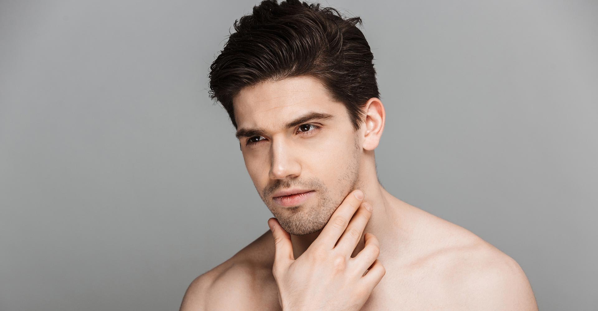 Beauty portrait of half naked pensive young man looking away