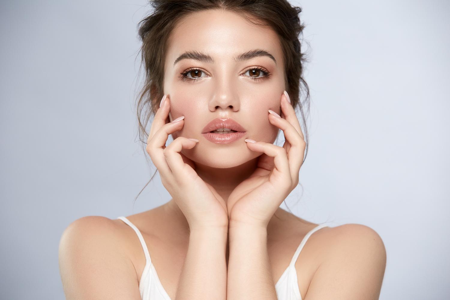 Beauty portrait of a woman touching her face